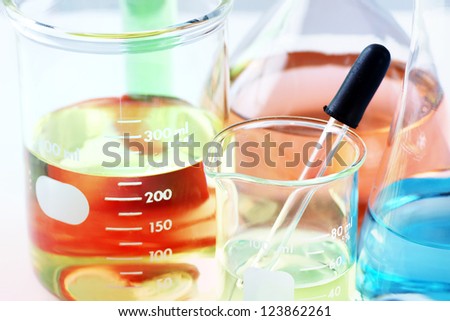Science, research or chemistry background: interesting macro shot of laboratory glassware with colorful chemicals or liquids, stacked focus.