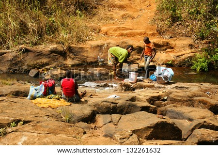 Fongo-Tongo, Cameroon - January 20: African Woman With Men Washing Clothes In A River On January 20, 2013 In Fongo Cameroon. Fresh Water Is Not Available In Most Rural Household In Cameroon.