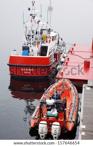 CANADA, QUEBEC, TADOUSSAC- AUGUST 8: Canadian coast guard vessel and zodiac docked at Tadoussac, Quebec, Canada on August 8, 2013. The Canadian coast guard is responsible for 8 million km2 of water.