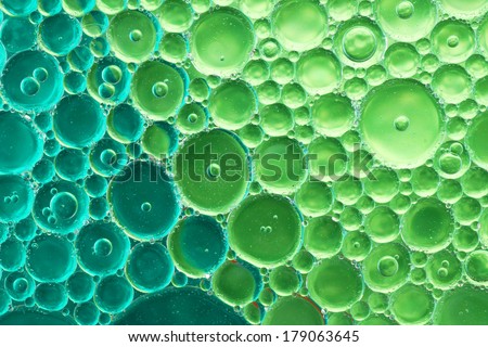 Oil and water over blue green background