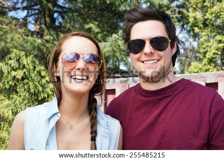 Happy smiling young couple with sunglasses