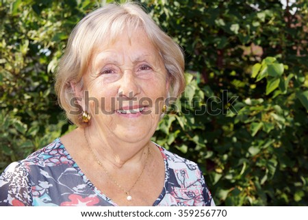 Candid portrait of happy senior woman outside