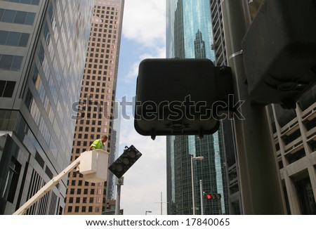 Houston, Texas - September 18, 2008: Public Safety Worker Fixing Tilted Red Traffic Light after Hurricane Ike (Editorial)