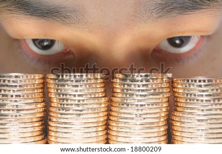 Asian Sly Eyes Eyeballing four stacks of gold shiny bullion money coins stacked up high