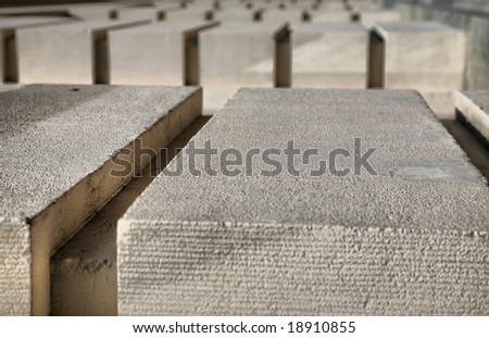 Row after row of concrete bocks with grooves cut into them fading into distance