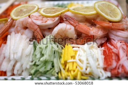 Asian Shrimp garnished with lemons, eggs, cucumbers, beets, and other spices