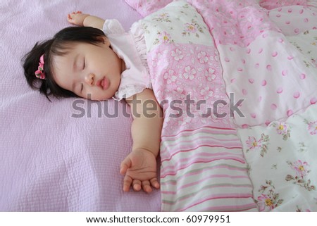 Beautiful Nine Month Old Asian Baby Infant Girl Sleeping with Arms Akimbo on Bed