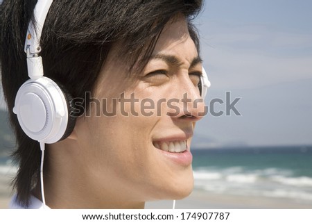 Japanese Man listening to music with headphones