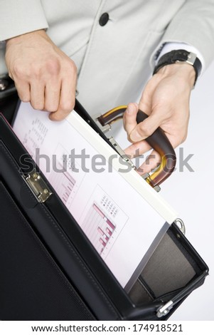 Businessman hand taking out the document from the bag