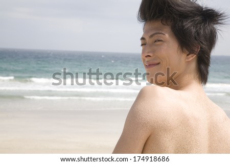 Japanese Man looking around on beach