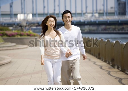 Japanese Couple walking by the river