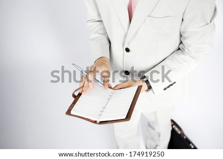 Businessman looking in his day planner