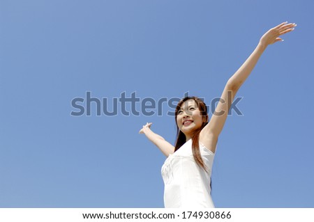 Japanese Woman who spread hands under the blue sky
