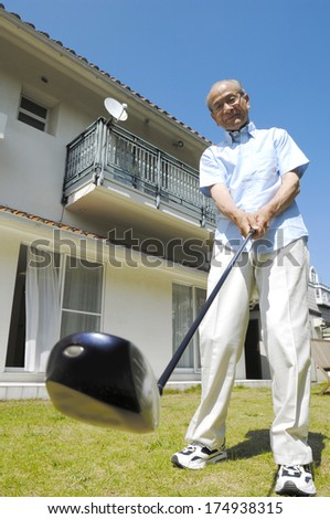 Japanese man practicing his Golf swing