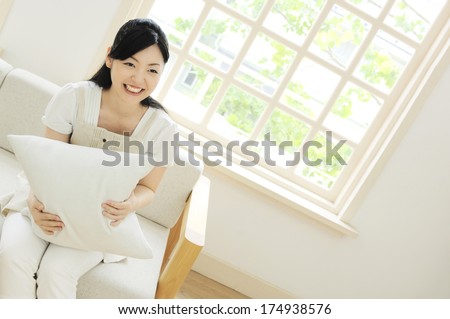 Japanese woman smiling on couch
