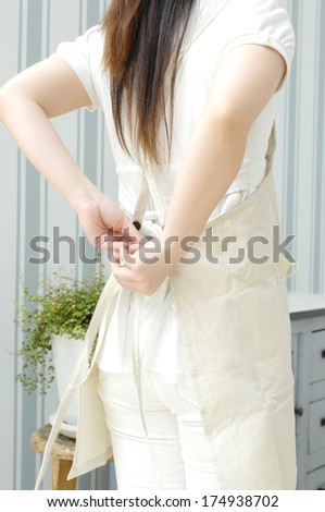 Woman tying apron
