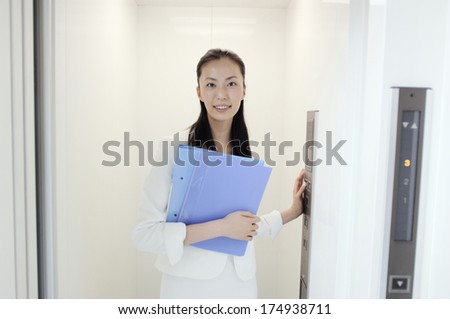 Japanese Business woman in elevator