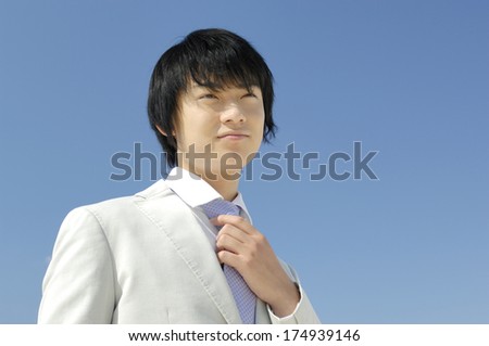 Japanese Businessman straightening the tie