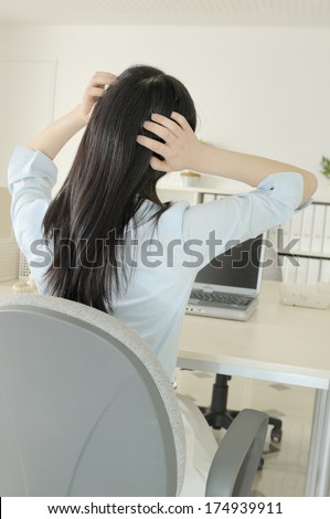 Back of a Japanese Woman worrying