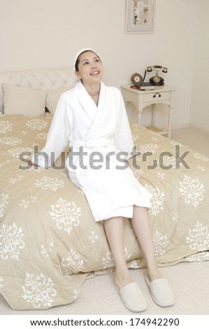 Japanese woman relaxing in bedroom
