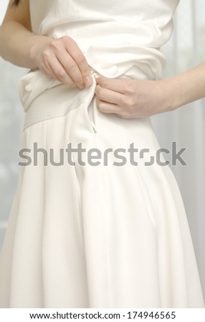 Japanese Woman zipping up her dress