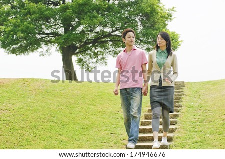 Japanese Couple walking down the stairs of the park