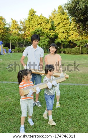Japanese Family carrying firewood for campfire