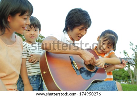 Japanese Father playing the guitar