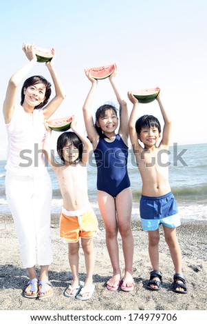 Japanese Mother and children raising watermelon over the head