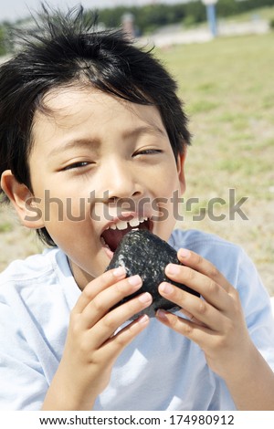 Japanese Boy eating rice balls
