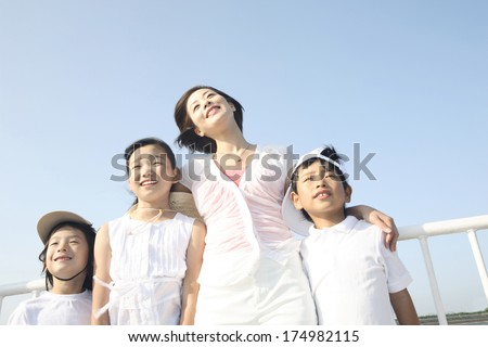 Japanese Mothers putting arms around shoulders with the children each other on the deck