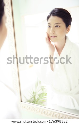 Japanese woman looking in the mirror