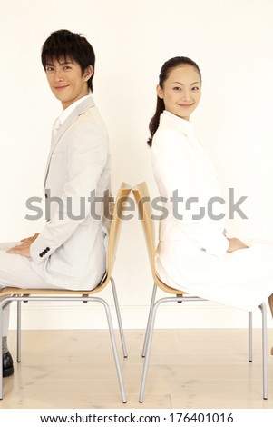 Japanese man and Japanese woman sitting back to back