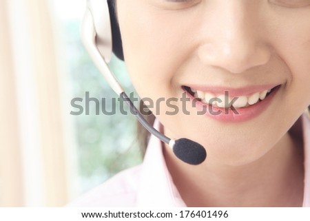 Mouth of a Japanese women talking on a hands free head set