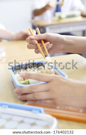 Hand of Japanese student eating lunch