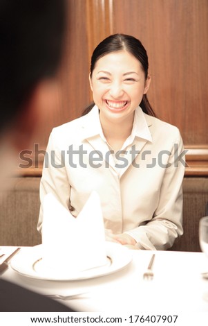 Japanese Secretary having conversation during dinner