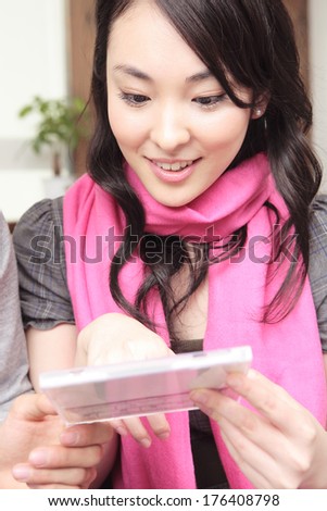 Japanese woman looking at the CD jacket