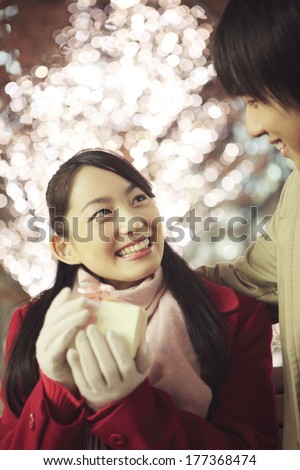 Japanese women holding out a gift to boyfriend