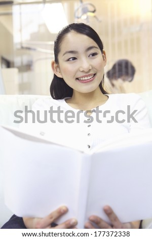 Japanese woman waiting for the order of the treatment in the waiting room