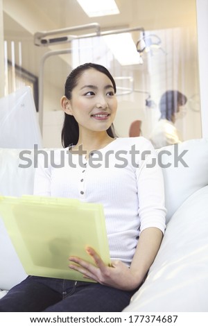 Japanese woman waiting for treatment in the waiting room