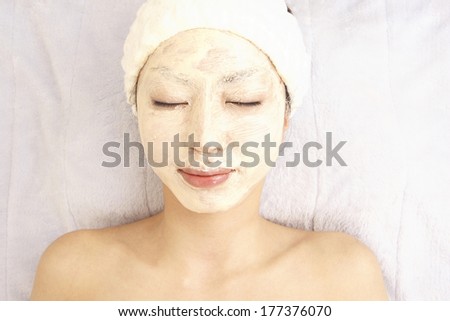 Japanese woman applies a face pack