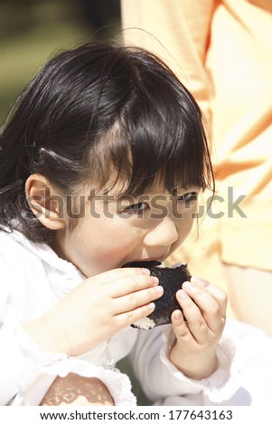 Japanese girl eating rice balls