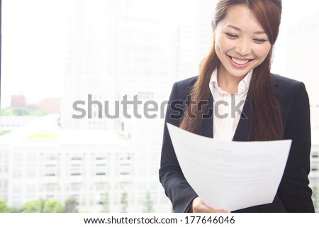 Japanese Office Lady reading an article of the document