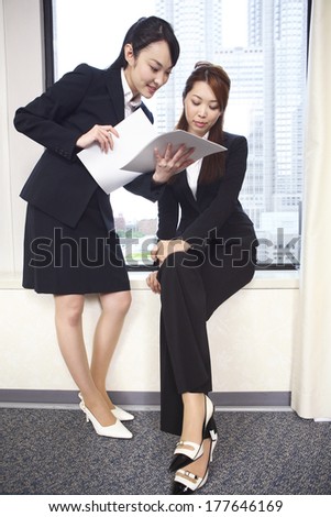 Japanese Office Ladies in the meeting while watching the material