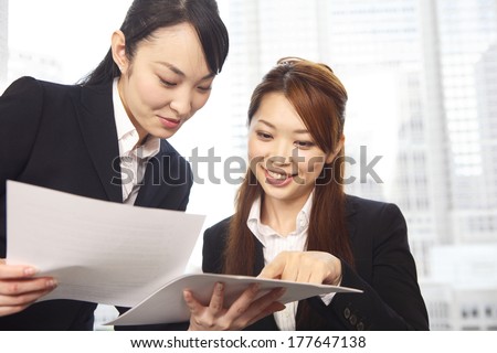 Japanese Office Lady in the meeting while watching the material