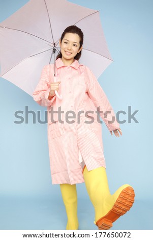 Japanese woman walking wearing rain gear