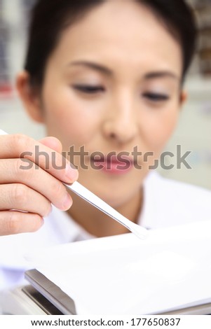 Japanese Pharmacist dispensing a medicine
