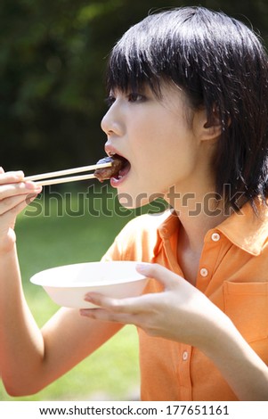 Japanese woman eating barbecue