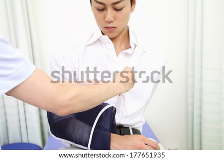 Japanese Male patient with his arm in a cast