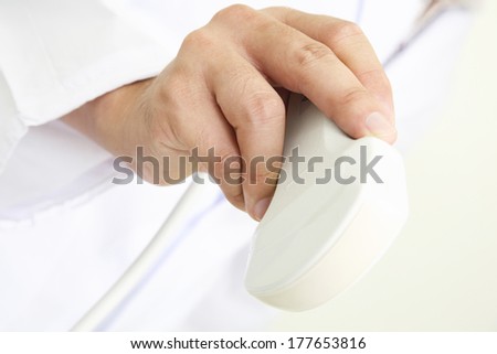 Hand of a doctor with medical device for ECHO